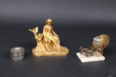 a gold statue of a woman sitting on top of a horse and carriage