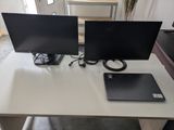 two monitors and a laptop sitting on a desk
