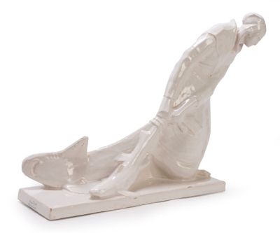statue of a man laying down on his back on a white surface