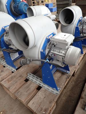 three blue and white blowers on a pallet in a warehouse