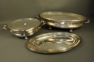 three silverplated serving dishes on stands on a table