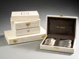 two white boxes with silverware in them sitting on a table