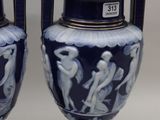 pair of blue and white vases sitting on top of a table