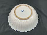 a white plate with a gold rim sitting on a table