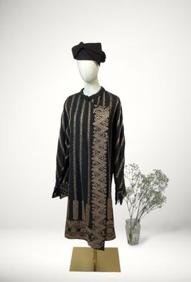 an image of a mannequin dressed in a black and gold dress and hat