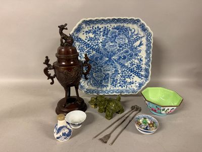 a blue and white plate, bowl, spoon, and other items on a table
