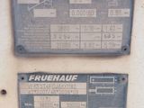 two signs on the side of a building that read fruehauf