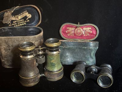 plein de vieilles jumelles et un étui posés sur une table