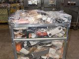 a metal cart with many items on it in a warehouse