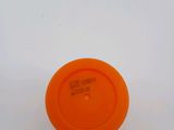 an orange frisbee sitting on top of a white surface