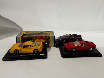 three toy cars that are on display on a table