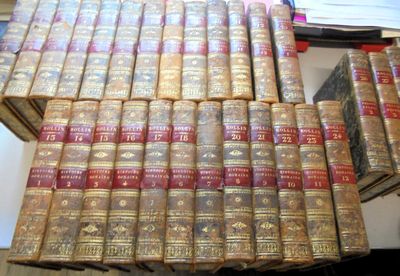 a lot of old books stacked on top of each other