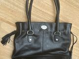 a black handbag on a wooden floor