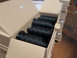 many spools of black thread in a box