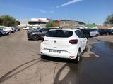 a white car parked in a parking lot next to other cars