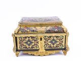 a gold and black box with flowers and birds on it
