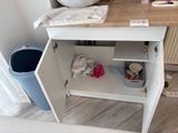 a sink and a trash can in a small room