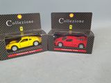 two toy cars are shown in boxes on a white surface