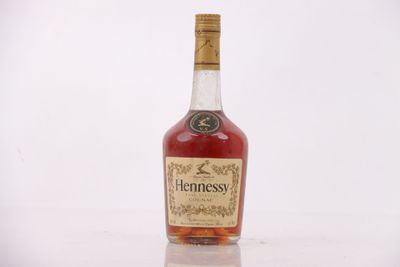 an image of a bottle of hennesy whiskey sitting on a table