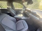the interior of a car with two leather seats and a center console