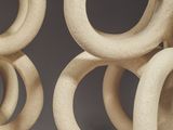 a close up of a sculpture of rings on a pole