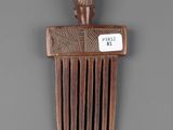 a wooden comb that has a tag on it