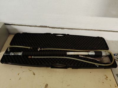 un outil dans un étui posé sur le sol