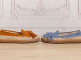 two pairs of blue and orange sued shoes on a wooden floor