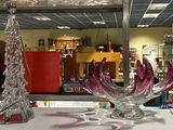 two glass vases sitting on a table in a store