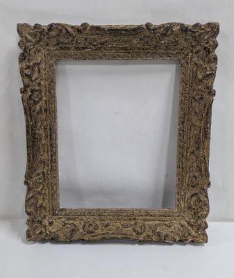 a gold ornate frame with a white background
