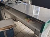 a desk with a laptop and a water bottle on it