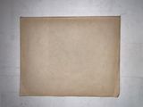 a piece of cardboard on a table with a piece of paper on it