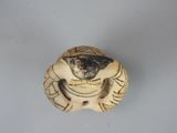 a small figurine of a man with a dog on it