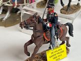 many figurines of soldiers riding on horses on display