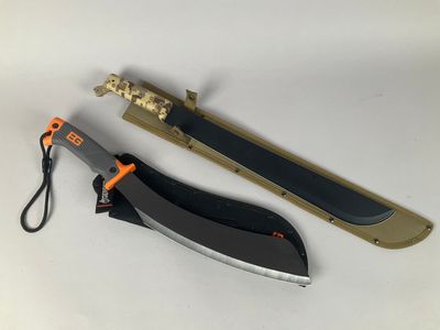 a knife that is laying on a table next to a knife