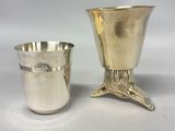 a silver cup and a silver beakle on a white background