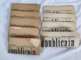 a lot of old newspapers stacked on top of each other