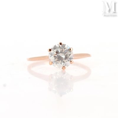 a close up of a diamond ring on a white surface