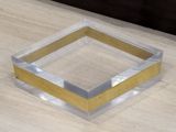 a square shaped glass object on a wooden table