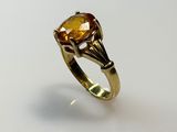 a close up of a gold ring with a citrine stone