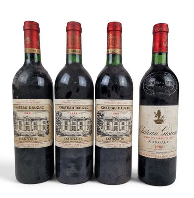 three bottles of red wine sit next to each other on a white surface