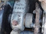 a close up of an old engine with a hose attached to it