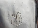 a silver plate with a monogram on it
