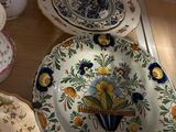 many plates and vases that are sitting on a table