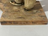a doll that is standing on top of a wooden block