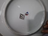 a person holding a white plate with a picture on it