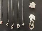 a collection of silver jewellery including a necklace, ring, and earrings