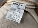 a close up of a label on a beige sweater