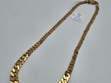 a gold chain necklace on a white background