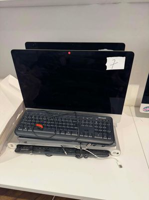a laptop computer sitting on a desk with a keyboard